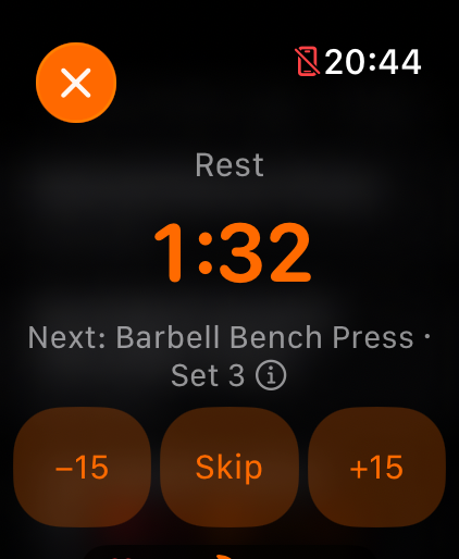 The rest timer on Apple Watch at 1:32, below it “Next: Barbell Bench Press · Set 3” and the buttons −15, Skip and +15